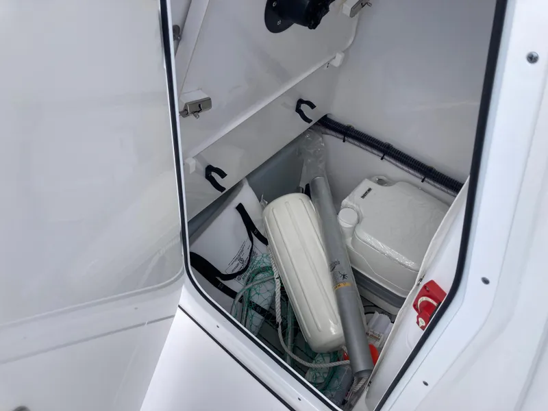 Slide: The Image of Storage compartment of 2022 Sportsman 241 Heritage boat with equipment and supplies. - 16