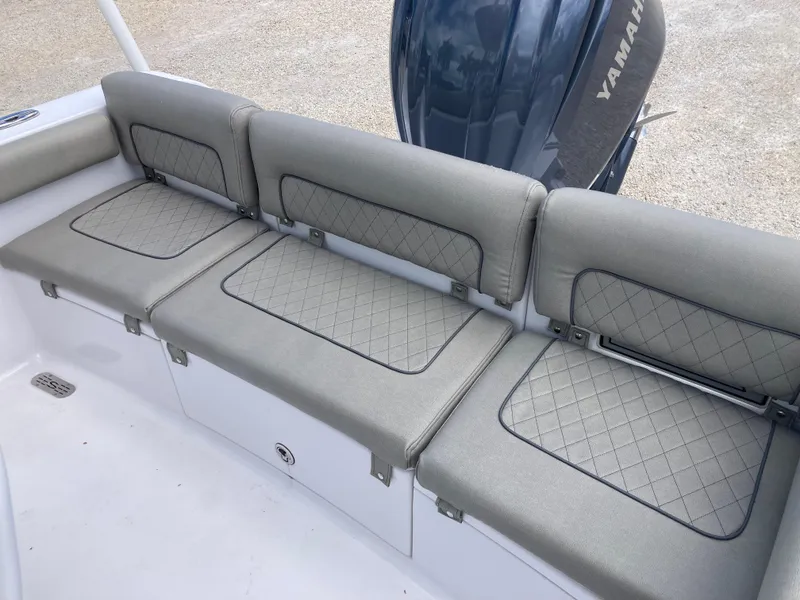 Slide: The Image of 2022 Sportsman 241 Heritage boat with cushioned seating and Yamaha engine. - 18