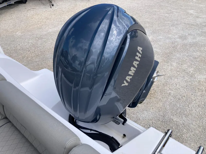 Slide: The Image of Yamaha outboard motor on 2022 Sportsman 241 Heritage boat, parked on gravel. - 19