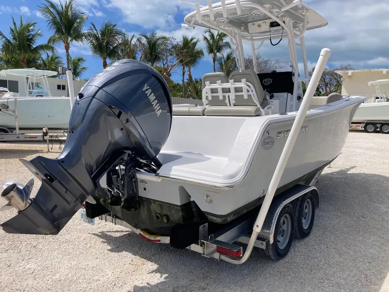 Slide: The Image of 2022 Sportsman 241 Heritage boat with Yamaha engine on trailer, palm trees in background. - 3