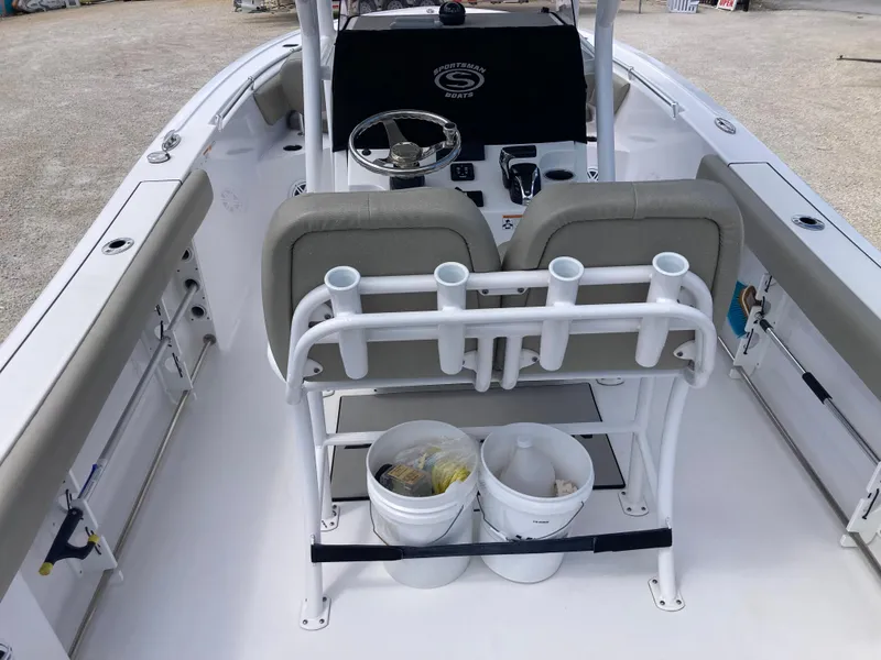Slide: The Image of 2022 Sportsman 241 Heritage boat interior with seating, steering wheel, and storage buckets. - 6