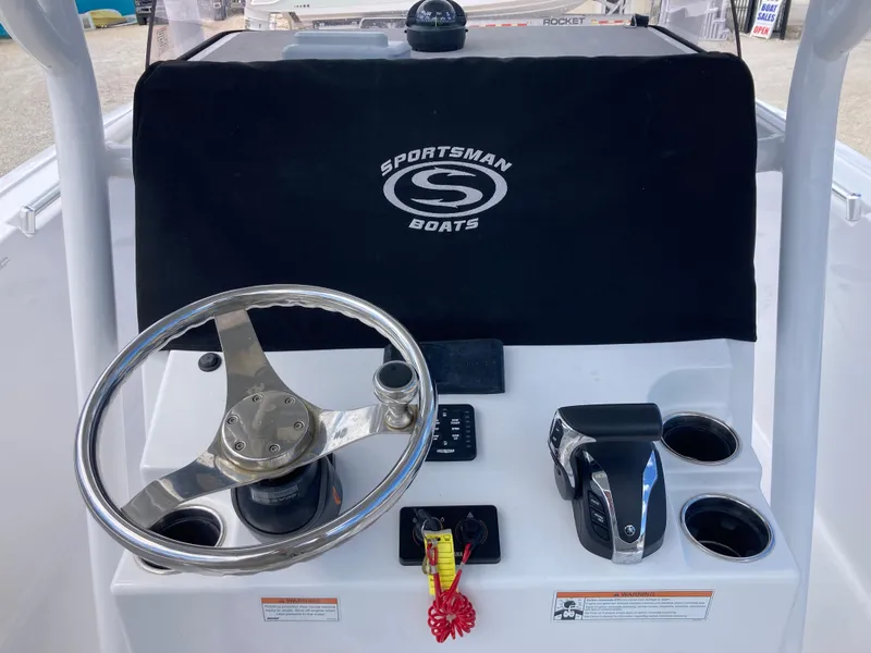 Slide: The Image of 2022 Sportsman 241 Heritage boat console with steering wheel and controls. - 8