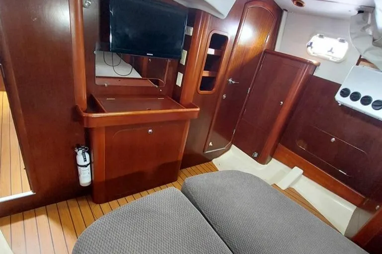 Slide: The Image of Interior of 1999 Beneteau Oceanis 40CC yacht with wood finish and modern amenities. - 14