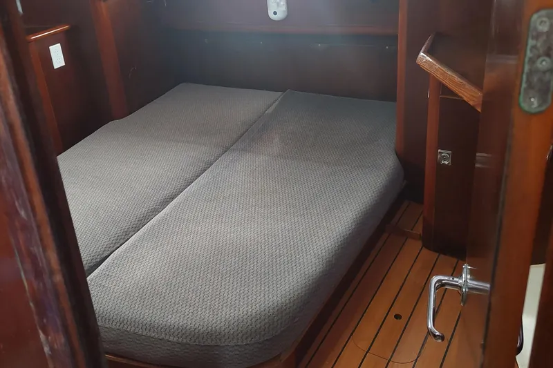 Slide: The Image of Cabin interior of 1999 Beneteau Oceanis 40CC with wooden flooring and double bed. - 16
