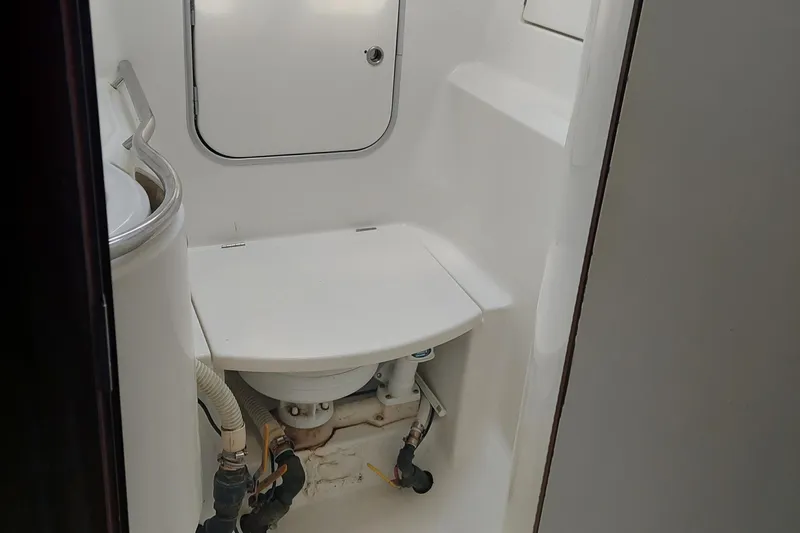 Slide: The Image of 1999 Beneteau Oceanis 40CC yacht bathroom with compact toilet and storage. - 21