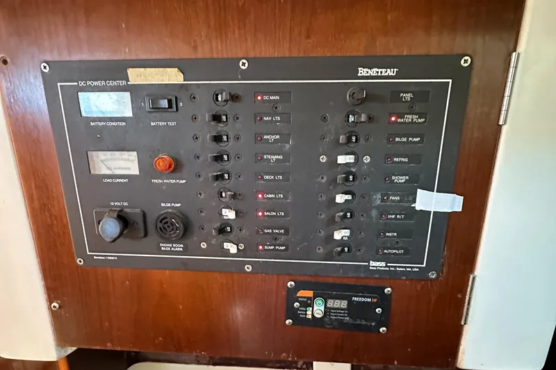Slide: The Image of Control panel of a 1999 Beneteau Oceanis 40CC sailboat, featuring various switches and indicators. - 22