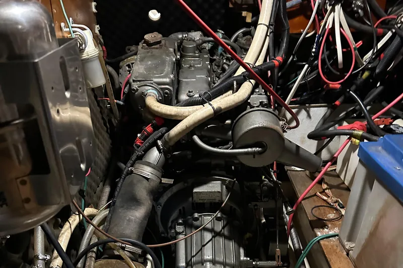 Slide: The Image of Engine compartment of a 1999 Beneteau Oceanis 400 sailboat, showing detailed mechanical components. - 23