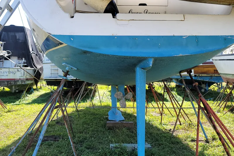 Slide: The Image of 1999 Beneteau Oceanis 40CC sailboat on stands, showcasing blue hull and keel. - 29