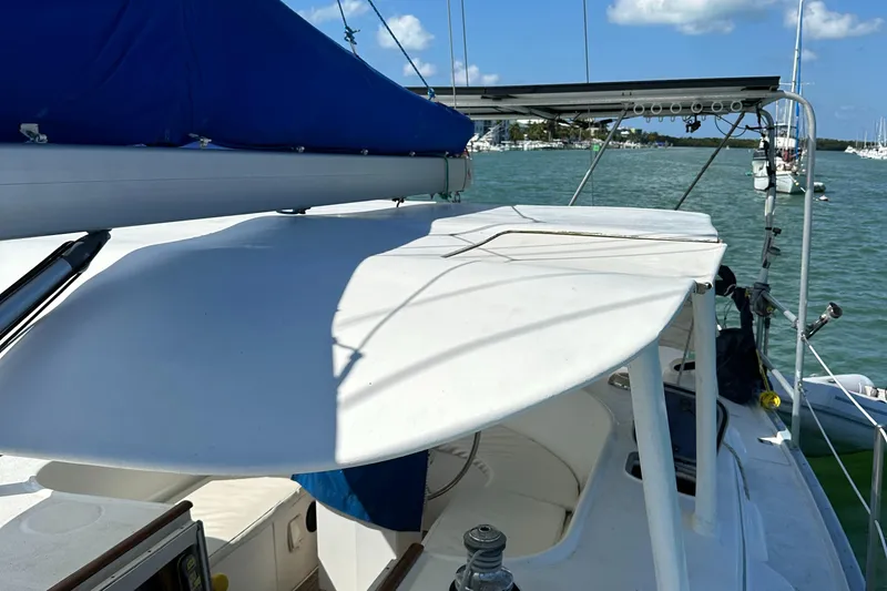 Slide: The Image of 1999 Beneteau Oceanis 40CC sailboat deck with blue sail cover, docked in marina. - 35