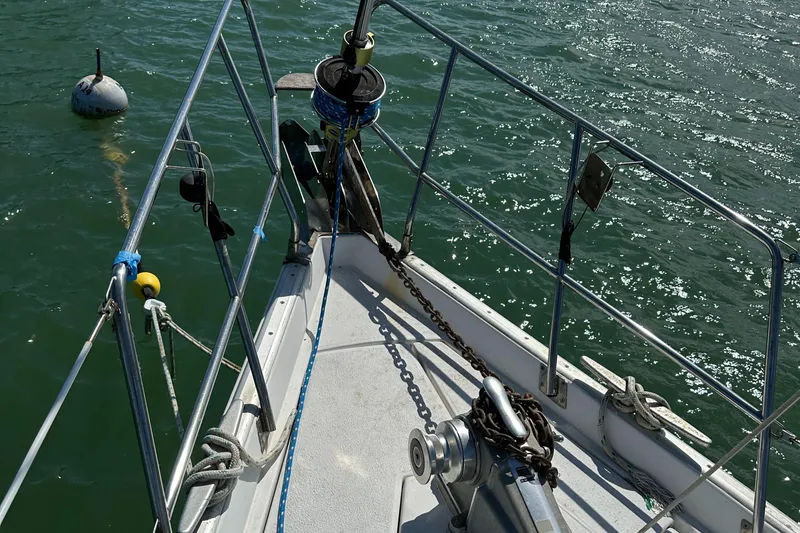 Slide: The Image of Bow of 1999 Beneteau Oceanis 40CC sailboat with anchor and railing in sunlight. - 38