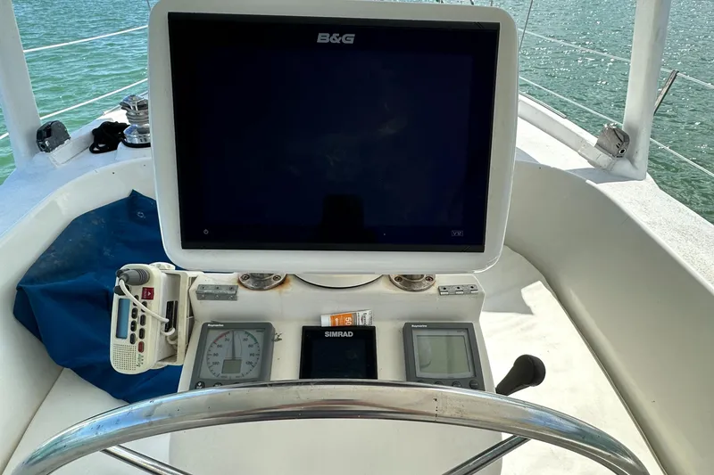 Slide: The Image of Cockpit of 1999 Beneteau Oceanis 40CC with navigation equipment and steering wheel. - 40