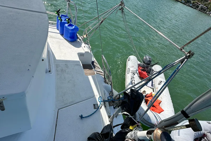 Slide: The Image of Beneteau Oceanis 40CC sailboat deck with dinghy and blue containers, 1999 model. - 42