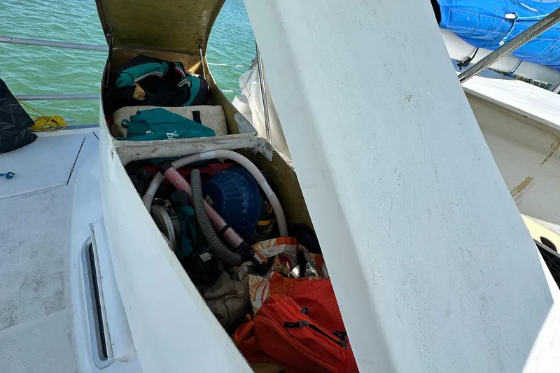 Slide: The Image of Open storage compartment on 1999 Beneteau Oceanis 40CC sailboat, revealing equipment and supplies. - 46
