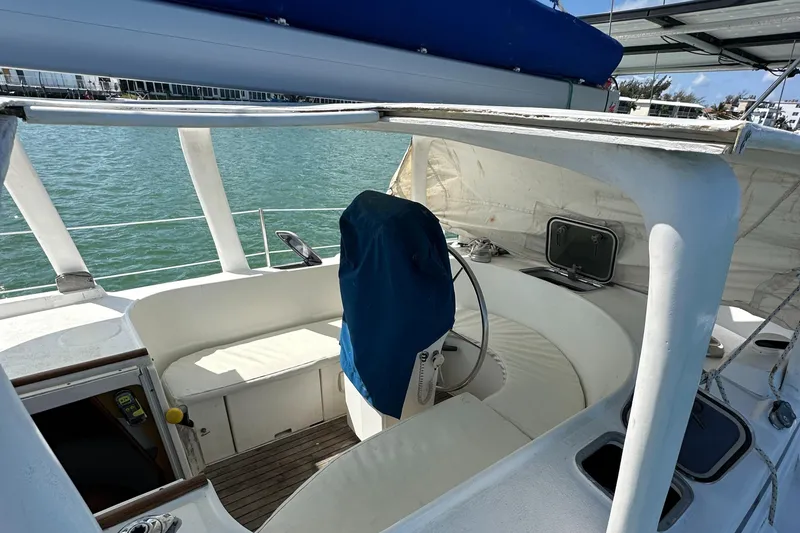 Slide: The Image of 1999 Beneteau Oceanis 40CC sailboat cockpit with covered steering wheel and seating. - 6