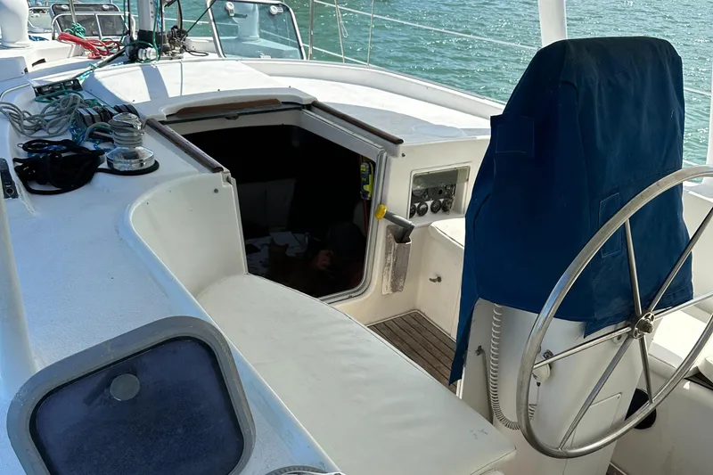 Slide: The Image of 1999 Beneteau Oceanis 40CC cockpit with steering wheel and open cabin entrance. - 7