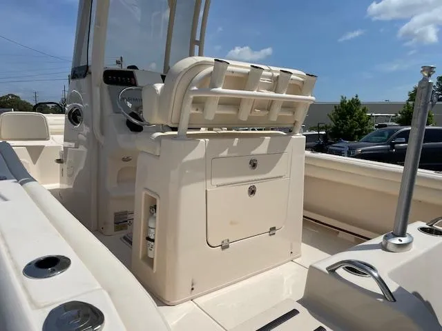 Slide: The Image of 2022 Grady-White Fisherman 216 boat interior with seating and console, under a clear blue sky. - 10