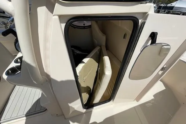 Slide: The Image of 2022 Grady-White Fisherman 216 boat storage compartment with open door and cushions inside. - 27