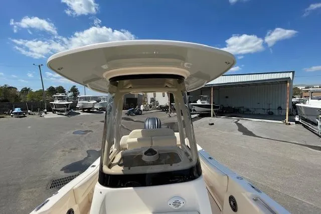 Slide: The Image of 2022 Grady-White Fisherman 216 boat with T-top, parked outdoors under blue sky. - 28