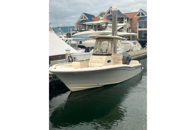 Slide: The Image of 2022 Grady-White Fisherman 216 boat docked at a marina with modern buildings. - 31