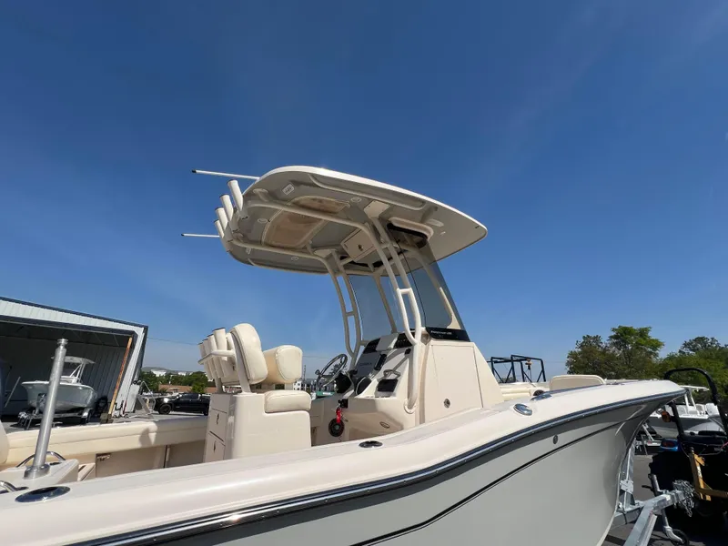 Slide: The Image of 2022 Grady-White Fisherman 216 boat with T-top under clear blue sky. - 5