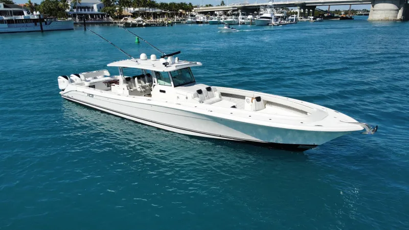 Slide: The Image of 2018 HCB 53 Sueños boat on clear blue water near a marina. - 1