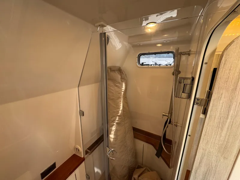 Slide: The Image of Interior of 2018 HCB 53 Sueños boat shower area with window and modern fixtures. - 27