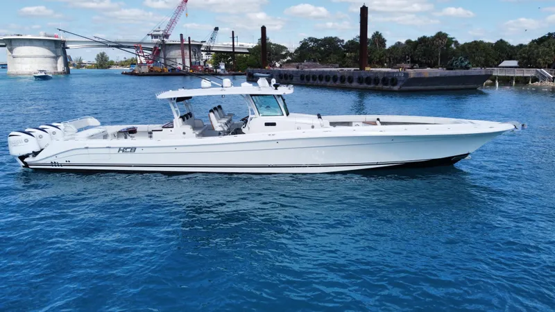 Slide: The Image of 2018 HCB 53 Sueños boat on blue water, with industrial background. - 4