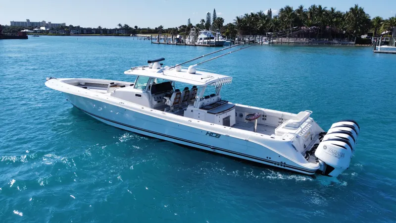 Slide: The Image of 2018 HCB 53 Sueños boat on clear blue water, featuring multiple outboard engines. - 8