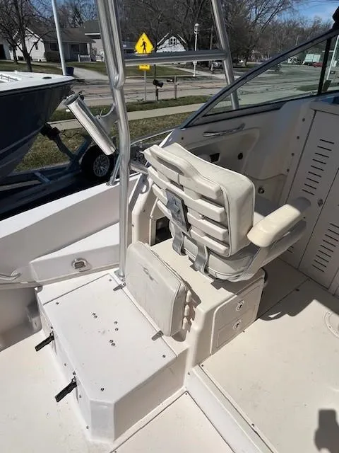 Slide: The Image of 2005 Grady-White 232 Gulfstream boat interior with white seating and control area. - 10