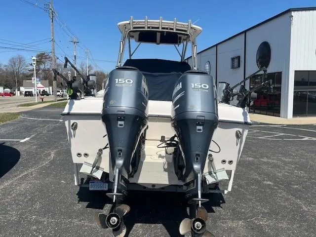 Slide: The Image of 2005 Grady-White 232 Gulfstream boat with twin Yamaha 150 engines, parked outdoors. - 11