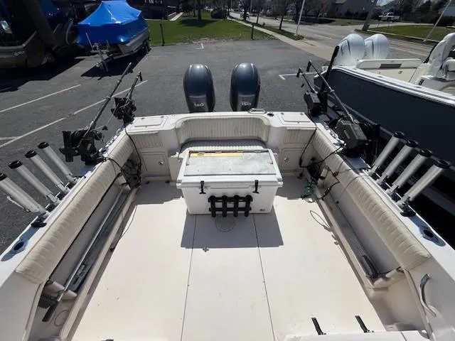 Slide: The Image of 2005 Grady-White 232 Gulfstream boat interior with dual engines and fishing rod holders. - 4