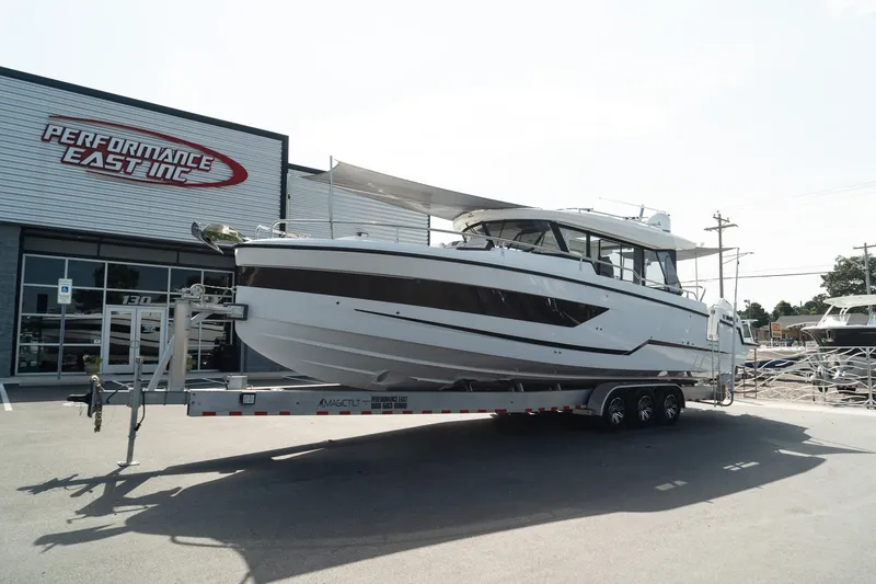 The Image of 2025 Wellcraft 38 Explorer boat on trailer outside Performance East Inc. dealership. - 0