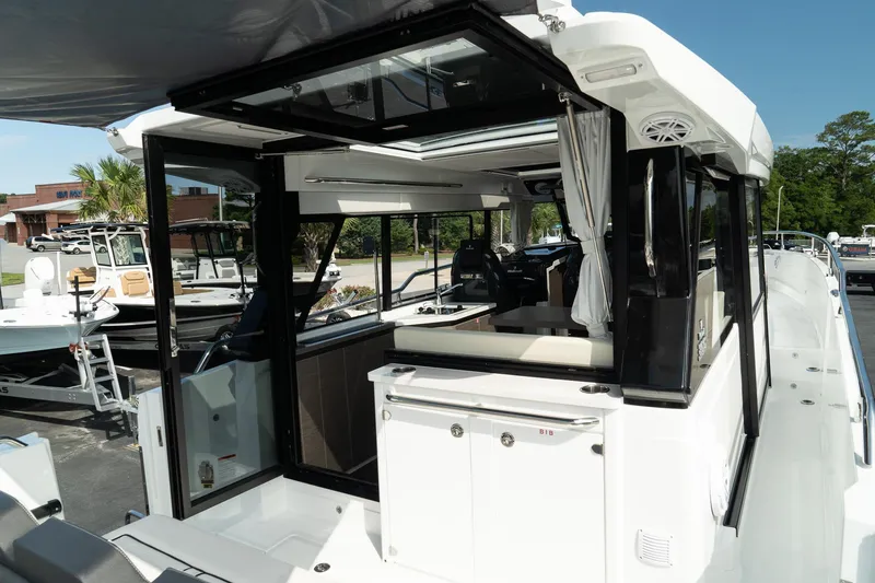 Slide: The Image of 2025 Wellcraft 38 Explorer boat interior with modern design and spacious seating area. - 11