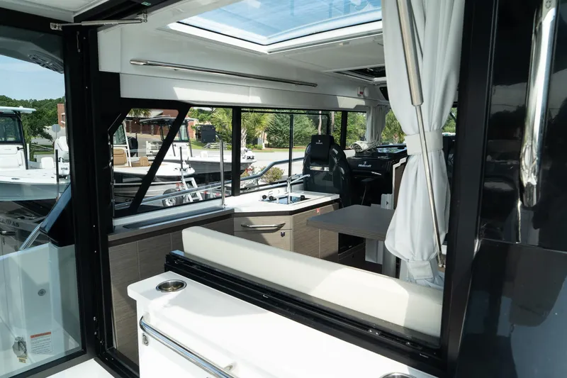 Slide: The Image of Interior of 2025 Wellcraft 38 Explorer boat with modern seating and helm. - 13