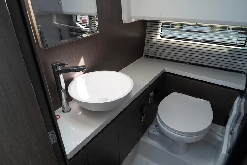 Slide: The Image of Modern bathroom interior of 2025 Wellcraft 38 Explorer yacht, featuring sleek sink and toilet. - 26