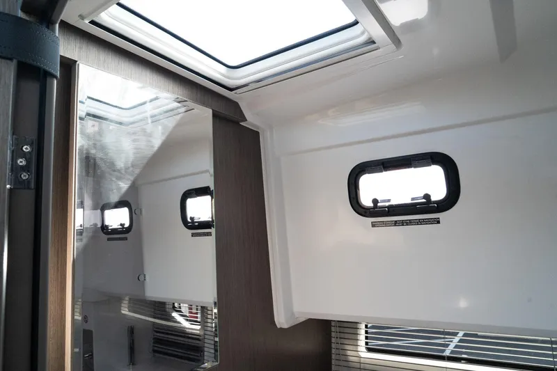 Slide: The Image of Interior cabin of 2025 Wellcraft 38 Explorer with skylight and porthole windows. - 30