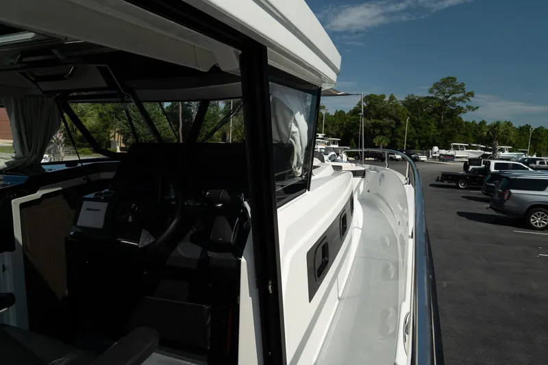 Slide: The Image of 2025 Wellcraft 38 Explorer boat exterior view in a parking lot. - 35