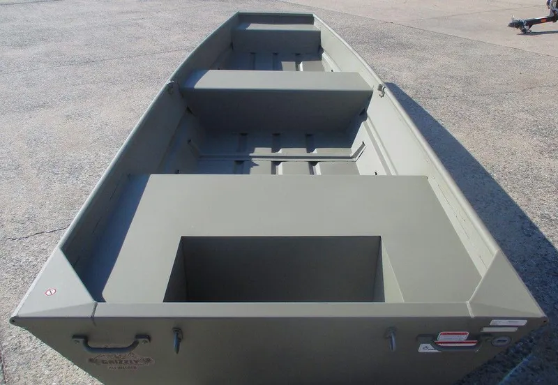 Slide: The Image of 2025 Tracker Grizzly® 1436 Utility boat, empty interior view, on concrete surface. - 3