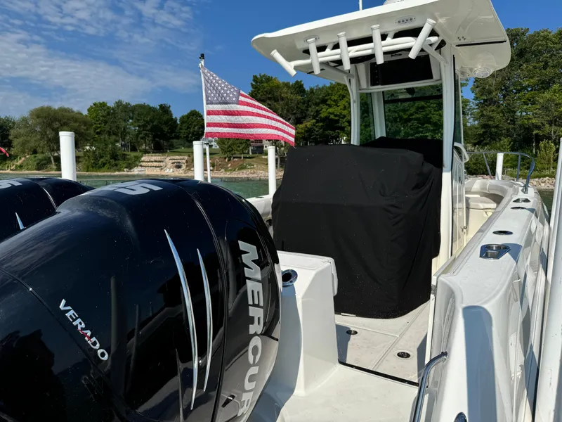 Slide: The Image of 2015 Boston Whaler 250 Outrage boat with dual Mercury Verado engines and American flag. - 10