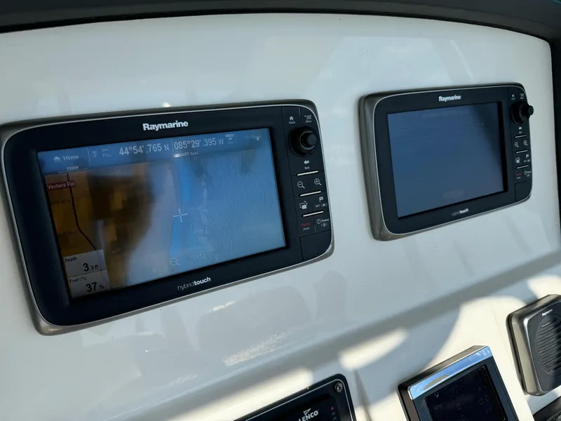 Slide: The Image of Raymarine navigation displays on 2015 Boston Whaler 250 Outrage boat dashboard. - 12