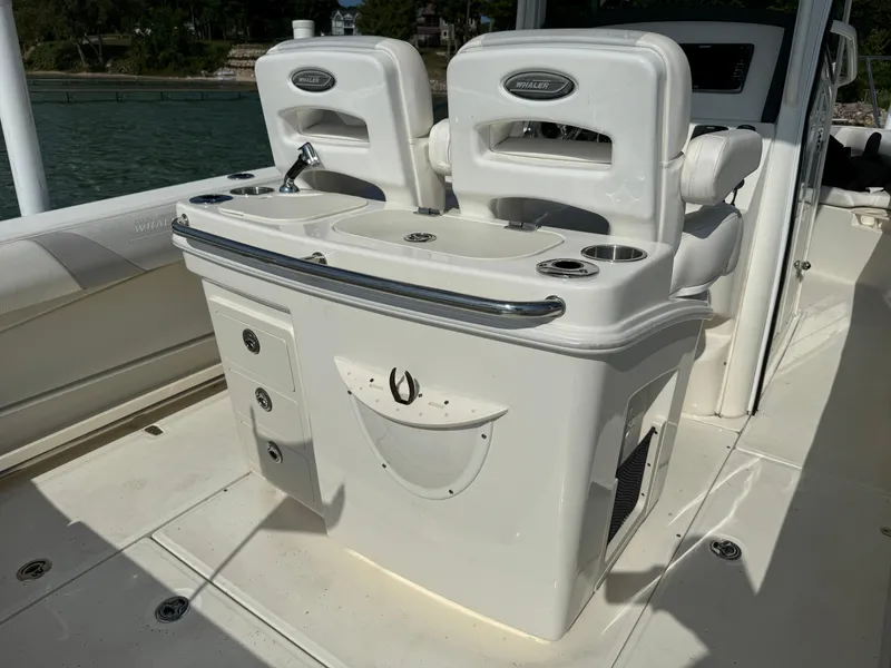 Slide: The Image of 2015 Boston Whaler 250 Outrage boat interior with seating and storage compartments. - 16
