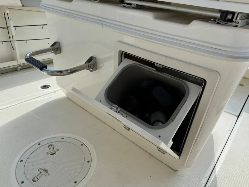 Slide: The Image of Boston Whaler 250 Outrage 2015 boat storage compartment with open lid. - 18
