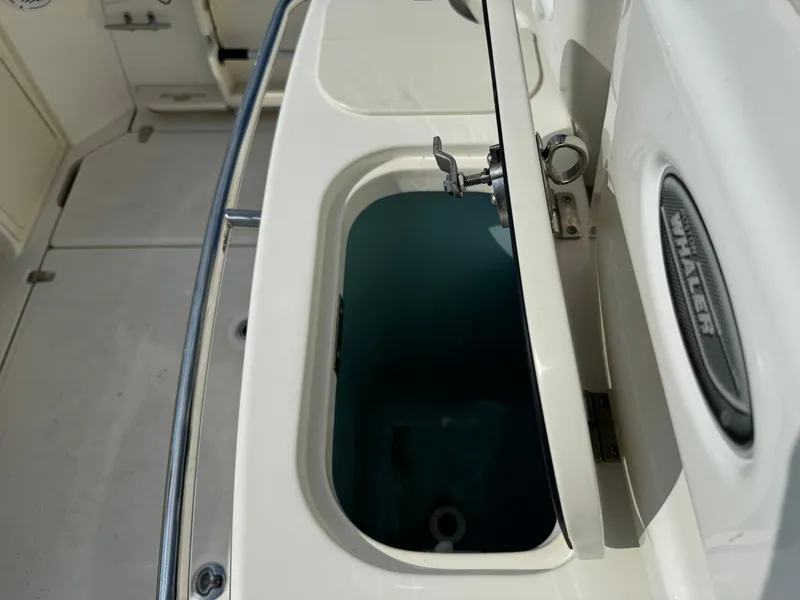 Slide: The Image of 2015 Boston Whaler 250 Outrage boat interior with open storage compartment. - 19