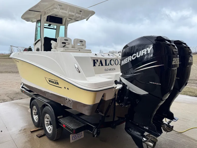 Slide: The Image of 2015 Boston Whaler 250 Outrage boat with dual Mercury engines on a trailer. - 2