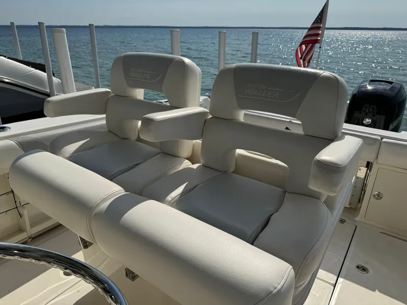 Slide: The Image of 2015 Boston Whaler 250 Outrage boat seats with ocean view and American flag. - 20