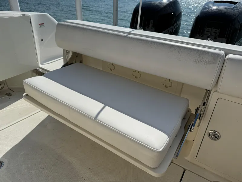 Slide: The Image of 2015 Boston Whaler 250 Outrage boat with foldable white bench seat and dual Mercury engines. - 23