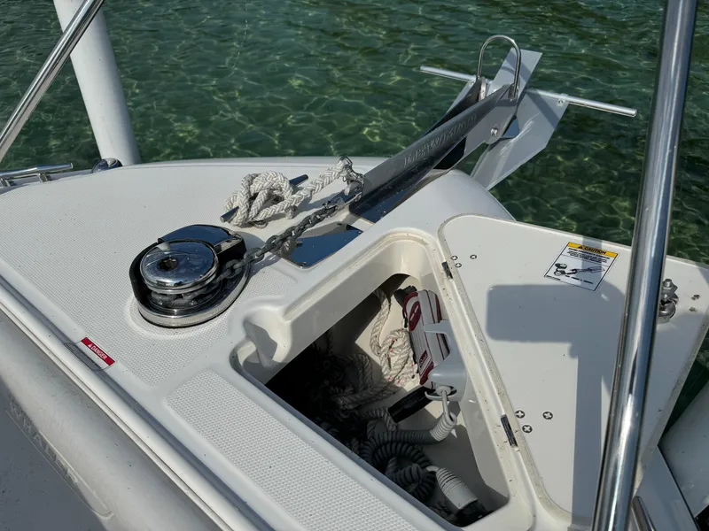 Slide: The Image of 2015 Boston Whaler 250 Outrage anchor system with rope and chain on clear water. - 26