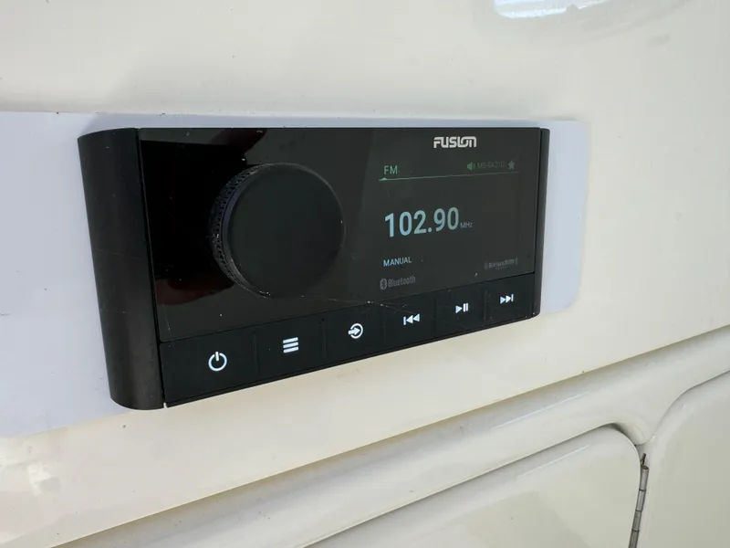 Slide: The Image of Fusion marine stereo on a 2015 Boston Whaler 250 Outrage, displaying FM 102.90 MHz. - 28