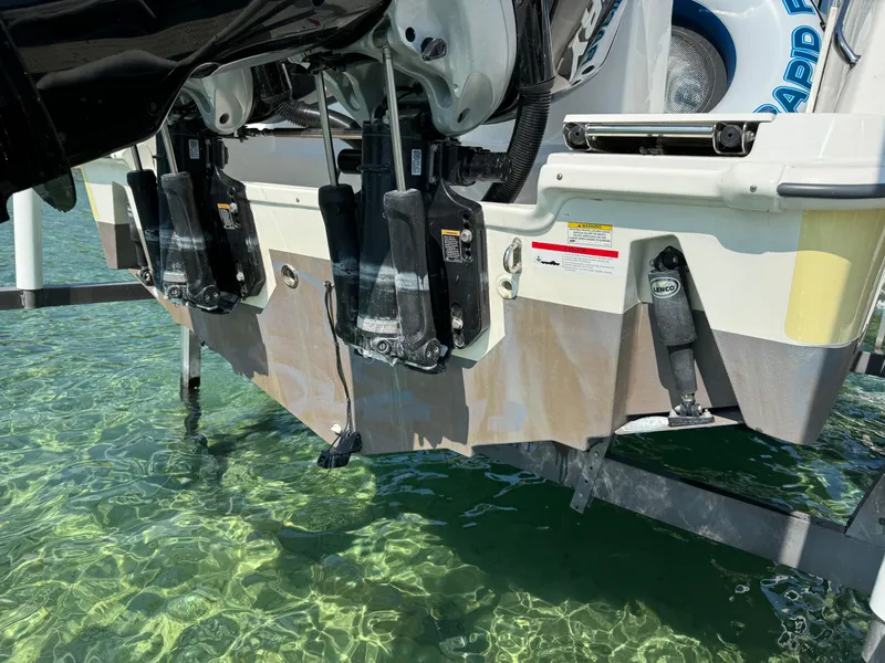 Slide: The Image of Boston Whaler 250 Outrage 2015 boat stern with engines above clear water. - 35