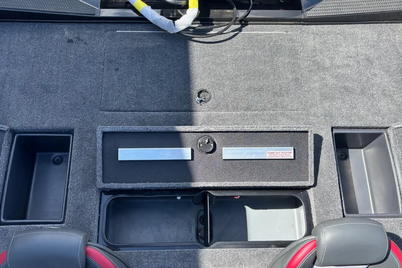 Slide: The Image of 2025 Ranger RT188 boat interior storage compartments with gray carpet and seating. - 14